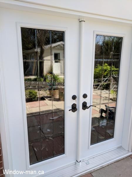 Patio French doors. Inswing full glass. White. Stained beveled Glass Patina caming. Installed
